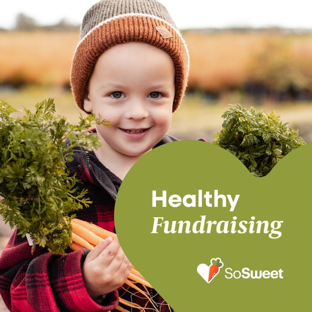 A young boy holding fresh carrots to represent healthy fundraising in New Zealand with So Sweet.