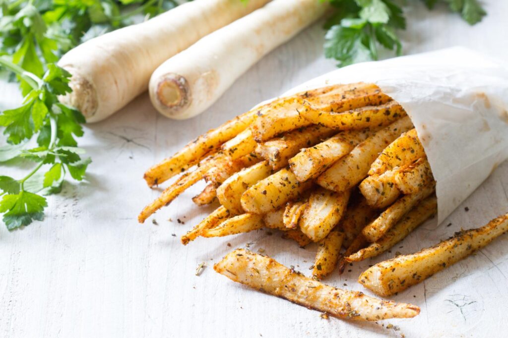 Crispy air fryer parsnip dipping sticks served with beetroot hummus
