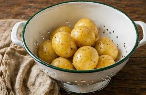 draining potatoes in colander after boiling